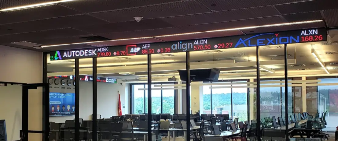 Rise LED Ticker displays spanning glass entryways in a building.