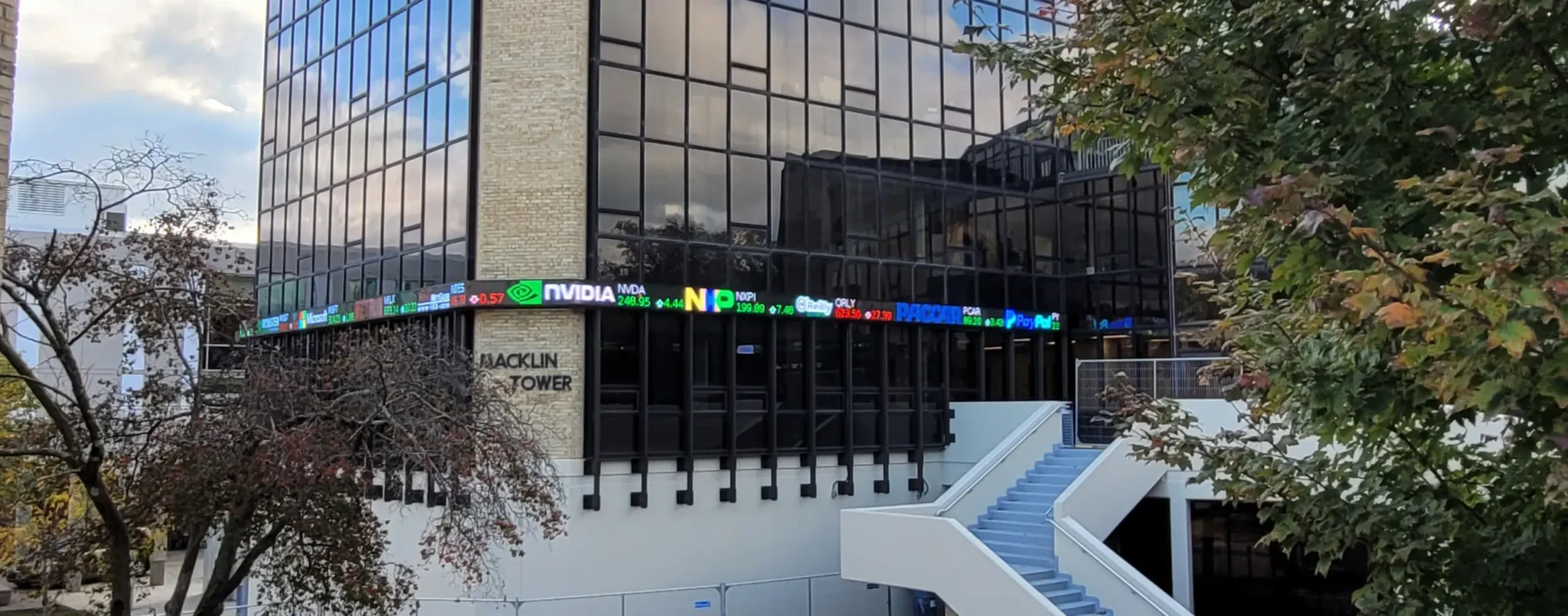 Outdoor LED ticker display mounted to a high rise building. By Rise Display.